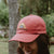West Coast Seeds - A Woman wearing an Organic Cotton Hat  in a garden, made in canada
