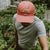 West Coast Seeds - A man wearing an Organic Cotton Hat  in a garden, made in canada
