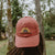 West Coast Seeds - A Woman wearing an Organic Cotton Hat  in a garden, made in canada
