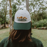 West Coast Seeds A woman wearing an Organic Cotton Hat  in a garden, made canada
