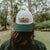 West Coast Seeds A woman wearing an Organic Cotton Hat  in a garden, made canada
