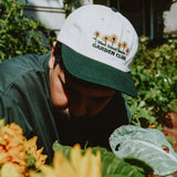 West Coast Seeds - A man wearing an Organic Cotton Hat  in a garden, made canada