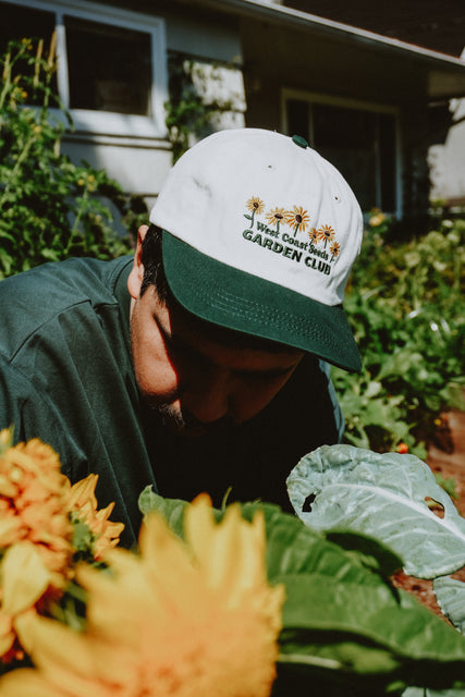 West Coast Seeds - A man wearing an Organic Cotton Hat  in a garden, made canada