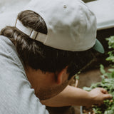 West Coast Seeds - A man wearing an Organic Cotton Hat  in a garden, made canada
