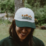West Coast Seeds - A woman wearing an Organic Cotton Hat  in a garden, made canada