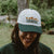 West Coast Seeds - A woman wearing an Organic Cotton Hat  in a garden, made canada