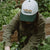 West Coast Seeds - A woman wearing an Organic Cotton Hat  in a garden, made canada