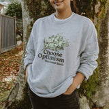 a girl wearing a sweatshirt from our swag collection outdoors